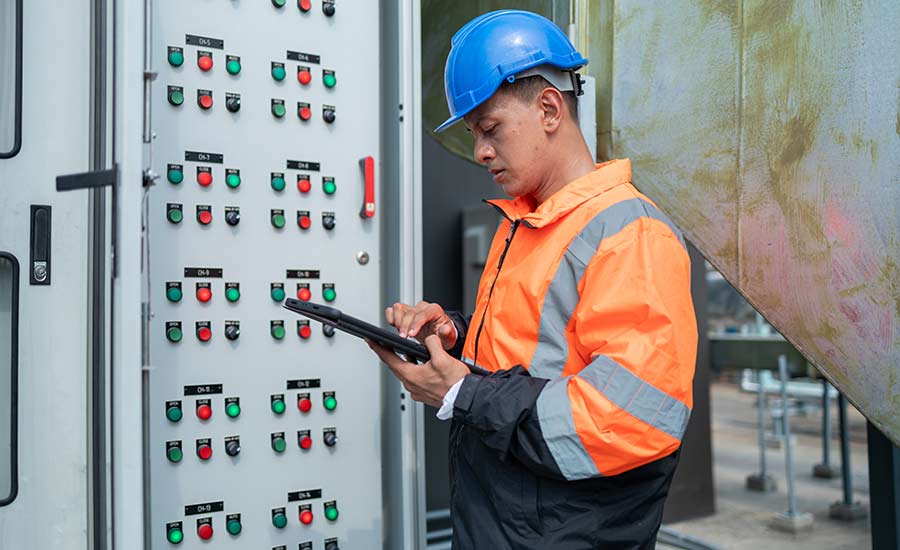 An HVAC technician with a tablet conducting an inspection​