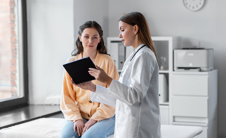 A female doctor talking to a young woman