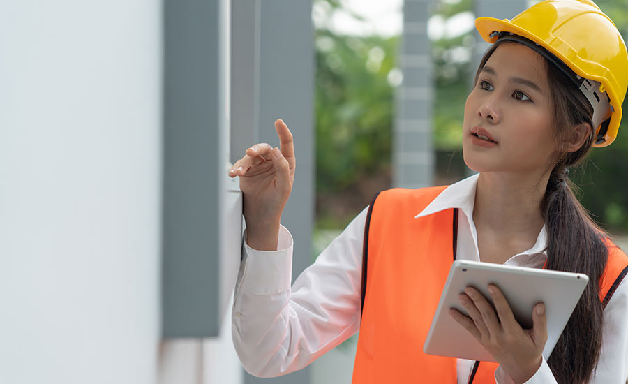 A female engineer conducting inspection of a house​