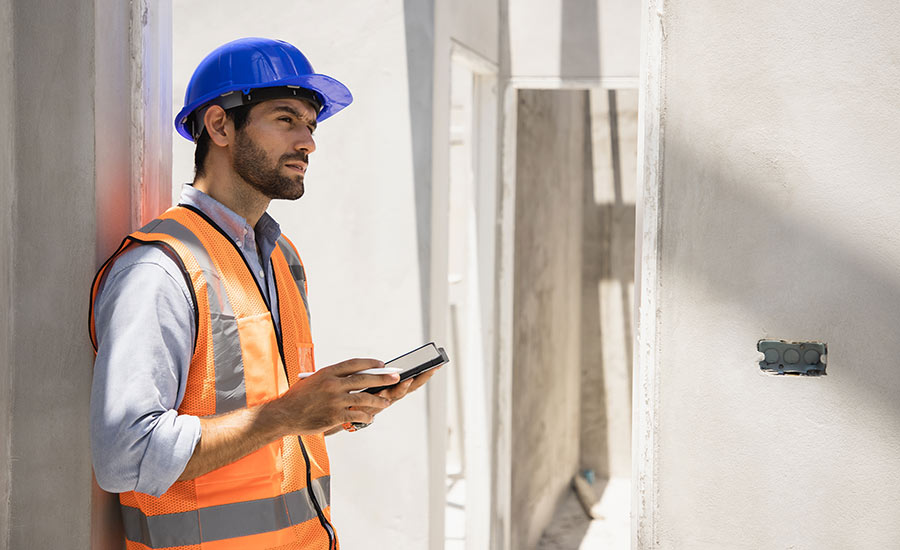 A construction engineer inspecting a building​