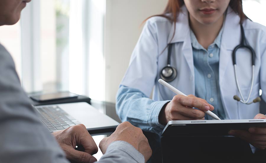 A doctor using a digital tablet​