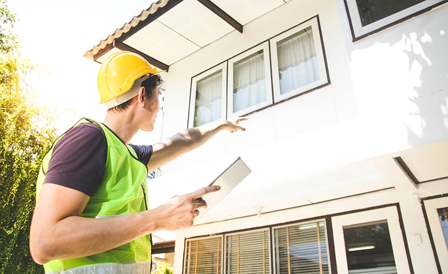 An FHA inspector and customer checking roof damage​