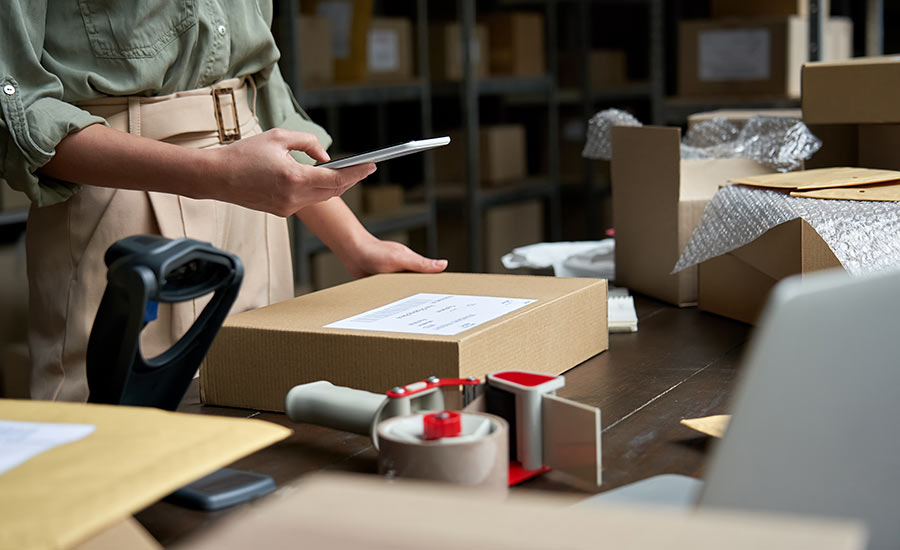 A business owner checking parcel info on her smartphone​