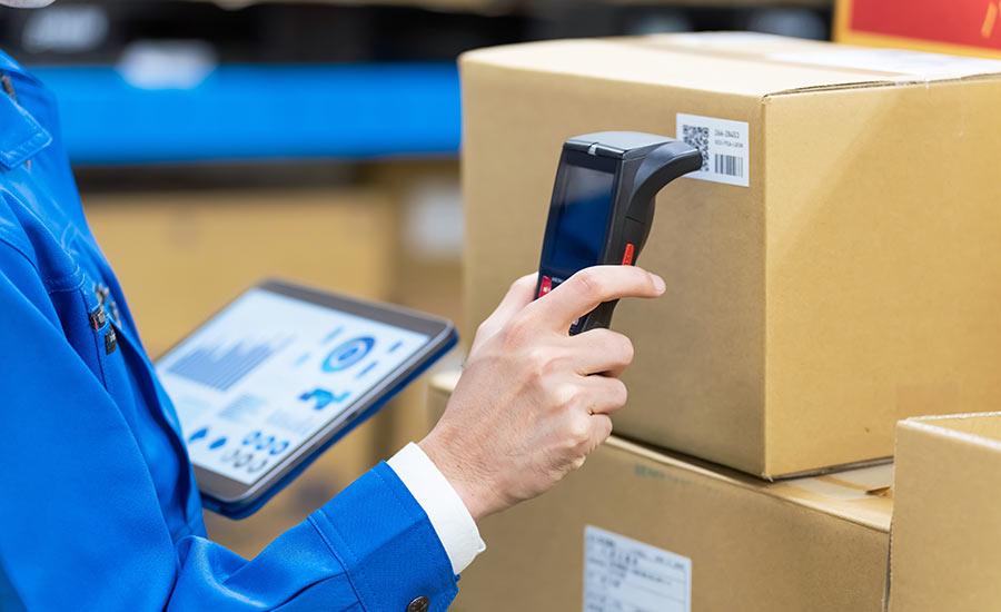 A person scanning inventory in a warehouse​