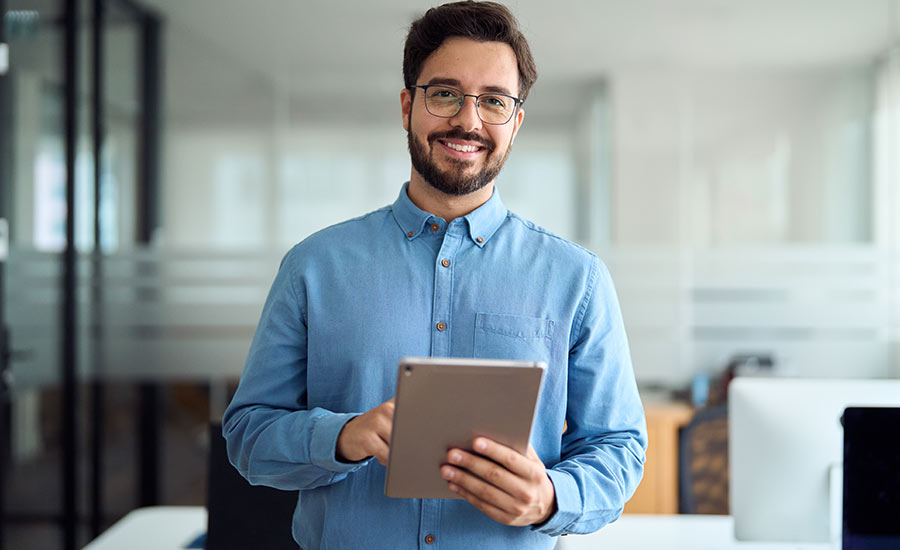 A smiling manager with a tablet​