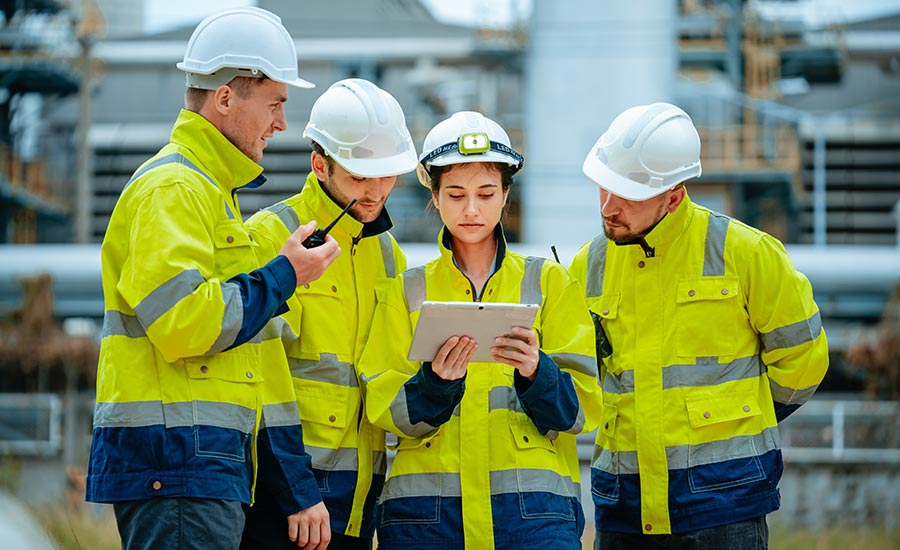 A female engineer coordinating shifts with her colleagues at a construction site